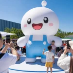 Giant inflatable cartoon mascot at an outdoor brand event