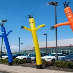 Air dancers lined up along a car dealership frontage